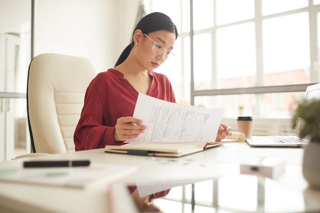 Photo of a woman reading her notes for an article about business financing
